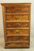 A late 19th century walnut five drawer tallboy with brass swing handles raised on plinth base. H.142