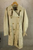 A modern gentlemens Burberry trench coat, with original label.