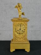 A 19th century French gilt metal mantle clock, the dial with black painted Roman numerals and twin