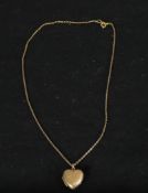 A 9ct back and front engraved gold locket on a 9ct gold trace chain. Clasp stamped 9ct. 4g W.23cm