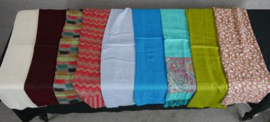 Ten assorted vintage plain and patterned cotton scarves.