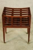 A Georgian style mahogany floor standing Canterbury raised on square tapering supports terminating
