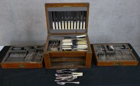 An early 20th century oak canteen of silver plated flatware. H.23 W.43 D.33cm