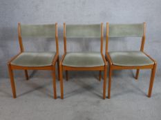 Three 1960s Farstrup Mobler Danish teak and wool dining chairs raised on tapering supports.