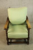 An early 20th century oak ajustable reclining armchair with bobbin twist and stick supports raised