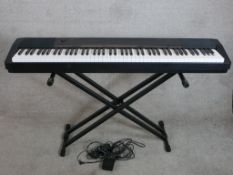 An electric Casio keyboard and stand. H.80 W.135cm
