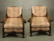 A pair of Georgian style carved beech framed and bergere arm chairs raised on carved cabriole