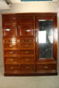 A 19th century mahogany single mirrored door compactum wardrobe with twin cupboard doors above