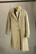 A modern gentlemens Burberry trench coat, with original label.