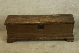 A 19th century stained beech chest with iron work strapwork hinges raised on shaped bracket feet.