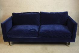 A contemporary blue upholstered two seater settee. H.71 W.200cm.