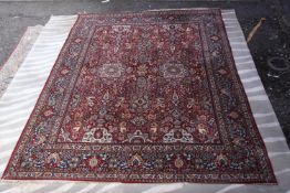 A large Persian carpet. L.394 W.328cm.