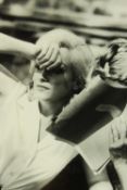 A framed black and white photograph of Marilyn Monroe partially covering her face. H.61 W.47cm.