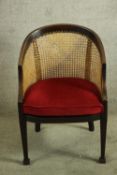 An Edwardian mahogany framed beregere bow back tub chair.