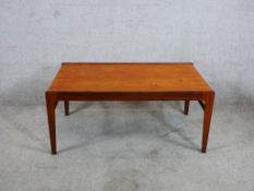 A 1960s/1970s Scandinavian teak rectangular table raised on square tapering supports. H.40 W.90 D.