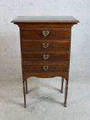 An Arts & Crafts mahogany four drawer music cabinet raised on four supports. H.92 W.59 D.37cm