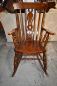 A Windsor style rocking chair. H.117 cm.