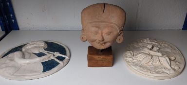 Two plaques and an ethnic figure.