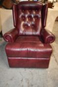 Armchair, leather upholstered with reclining action. H.104 cm.