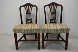 A pair of Hepplewhite style mahogany dining chairs.
