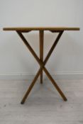 A vintage cross legged table. H.78 W.53 D.46 cm.