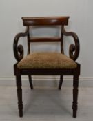 An early 19th century mahogany framed elbow chair.