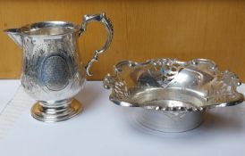 A silver engraved milk jug with floral design along with a pierced repousse design bon bon dish. Wei