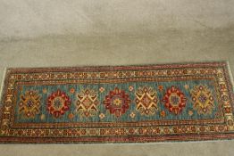 A Kazak runner. L.190 W.64cm.