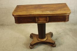 A William IV mahogany fold over table, the central hexagonal column raised from shaped platform base