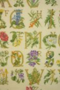 A framed alphabet embroidery. Signed with initials 'J.C' and dated 1984. Framed and glazed. 69 x