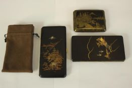 Three 19th century Japanese damascene cigarette cases with various designs, one with a gilded
