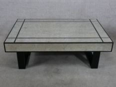 A contemporary mirror topped low coffee table raised on block supports. H.38 W.120 D.76cm