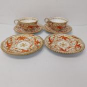 Four 19th century hand painted and gilded scrolling foliate design porcelain saucers and two