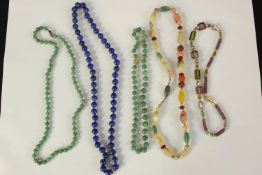 A collection of five necklaces. Two made from jade. The largest measures L.33 cm.