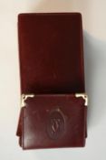A pair of maroon leather cased Cartier bi-colour gold plated prescription sunglasses. Signed Cartier