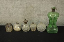 A collection of silver topped glassware. A mix of colour and style with makers marks to the tops.