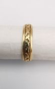 A 14 carat yellow gold engraved wedding band. Stamped 14K with engraved inscription. Ring size K.