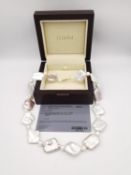 A boxed AAAA Keshi pearl and fresh water white pearl necklace with 18 carat yellow gold clasp. The