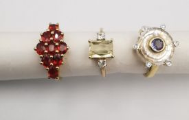 Three 20th century 9 carat gold gem-set rings, two with certificates. A tanzanite, quartz and