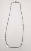 A Theo Fennell 18ct black gold and diamond spectacle chain, studded with ten round brilliant cut