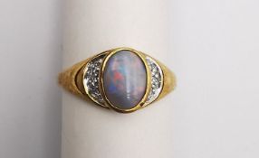A 9ct opal and diamond flanked solitaire ring. Set to centre with an oval cabochon black opal with