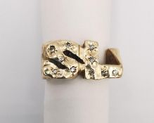 A 9ct gold textured monogram dress ring, in the form of the letters SL. Studded with ten round old