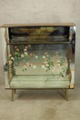 A mid century glass drinks cabinet with maker's label. (Some damage). H.115 W.104cm.
