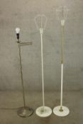 A brass standard lamp with articulated arm along with two other standard lamps H.130cm. (largest)