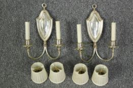 A pair of silver coloured wall lights with matching shades. Each measuring H.33 x W.25 cm.