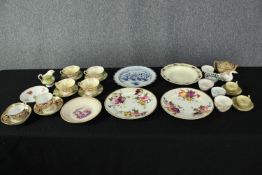 A mixed collection of nineteenth century porcelain to include cups and saucers, sugar pots and a