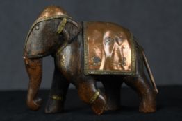 A carved hardwood elephant with copper decoration. The copper is highly detailed with beading to the