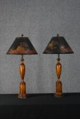 A pair of turned Chinese style lamps with hand painted shades. The shades feature pagodas and a