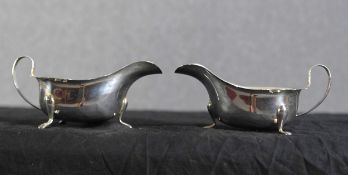 Two silver jugs with a combined weight of 216g. Hallmarks of the crown, a 'q' and 'E.V'. each