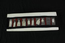 Zoë Hirson. Fabric textile. Nine figures. Signed and dated on the back. H.17 x W.45 cm.